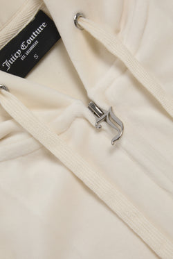 Displays the cream classic 'Juicy' branded velour Robertson hoodie featuring the juicy zip