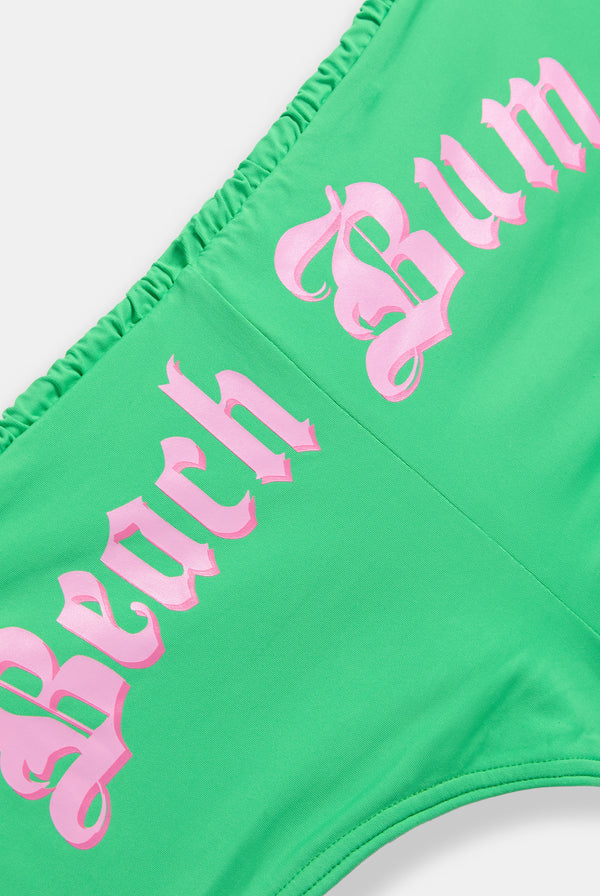 Displays the island green Roxy and juicy Couture cheeky bikini bottom featuring the beach bum branding 