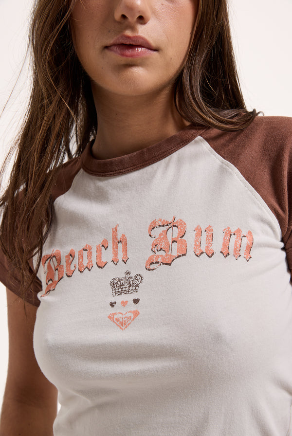 Displays a model wearing the Coconut Milk Roxy & Juicy Couture raglan graphic tee 