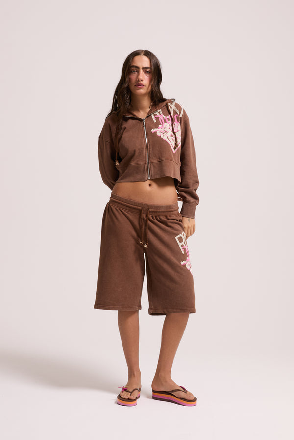 Displays a model wearing the Tiramisu Roxy & Juicy couture boxy hoodie 