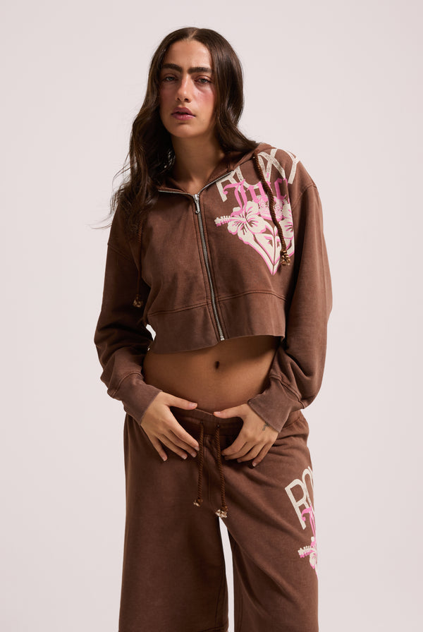 Displays a model wearing the Tiramisu Roxy & Juicy couture boxy hoodie 