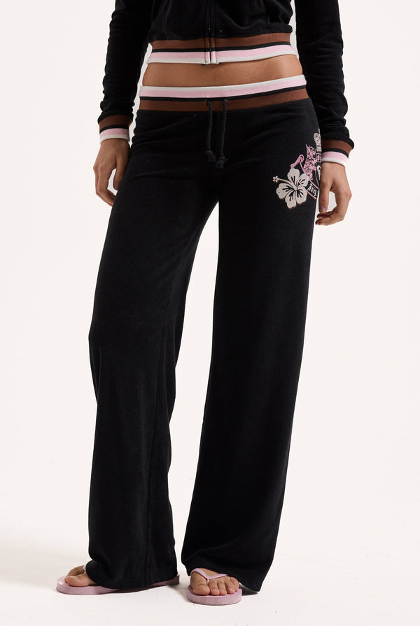 Displays a model wearing the Black Roxy & Juicy Couture Terry towelling og straight  bottoms