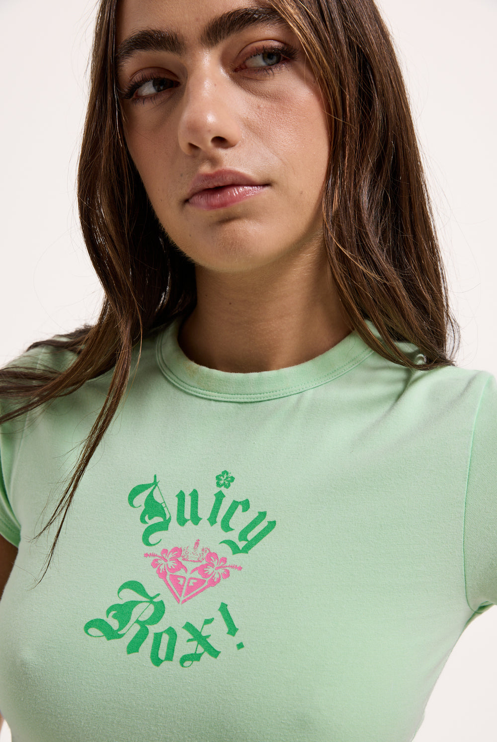 Displays a model wearing the Green Ash Roxy & Juicy couture baby tee 