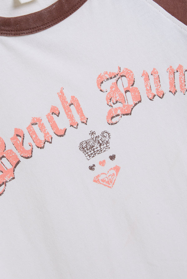 Displays the Coconut Milk Roxy & Juicy Couture raglan graphic tee featuring the beach bum branding 