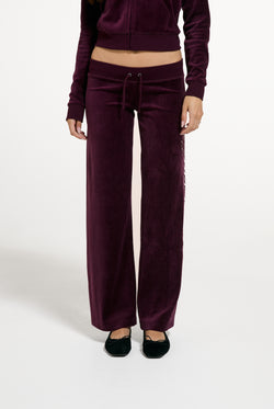 Displays a model wearing the Winetasting 'Juicy' branded Cotton Velour Ultra Lowrise Straight Leg Trackpant