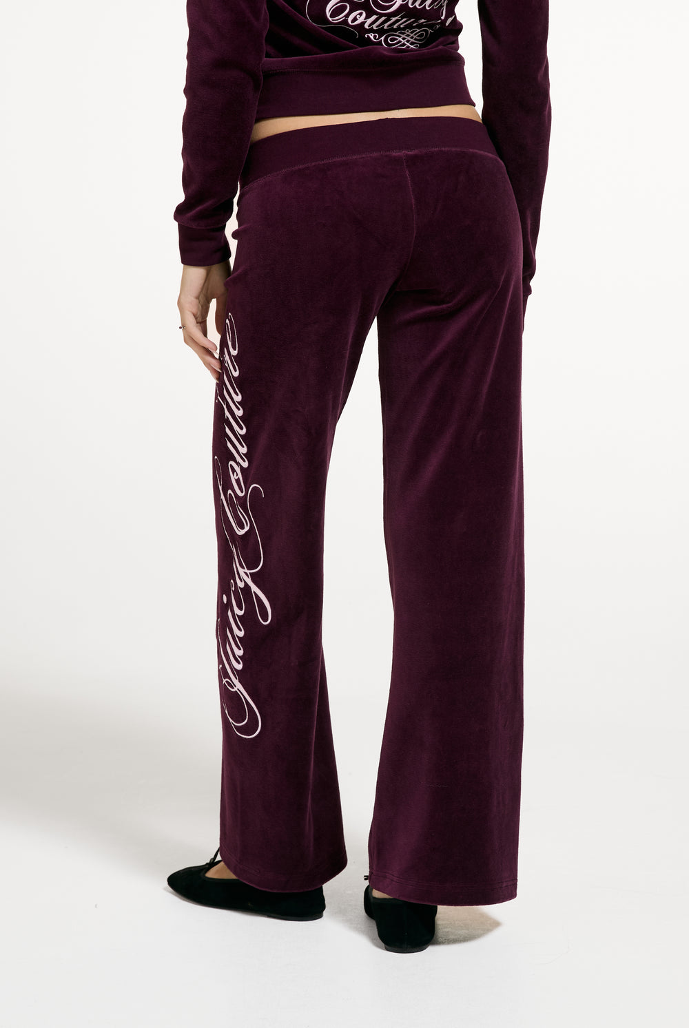 Displays a model wearing the Winetasting 'Juicy' branded Cotton Velour Ultra Lowrise Straight Leg Trackpant