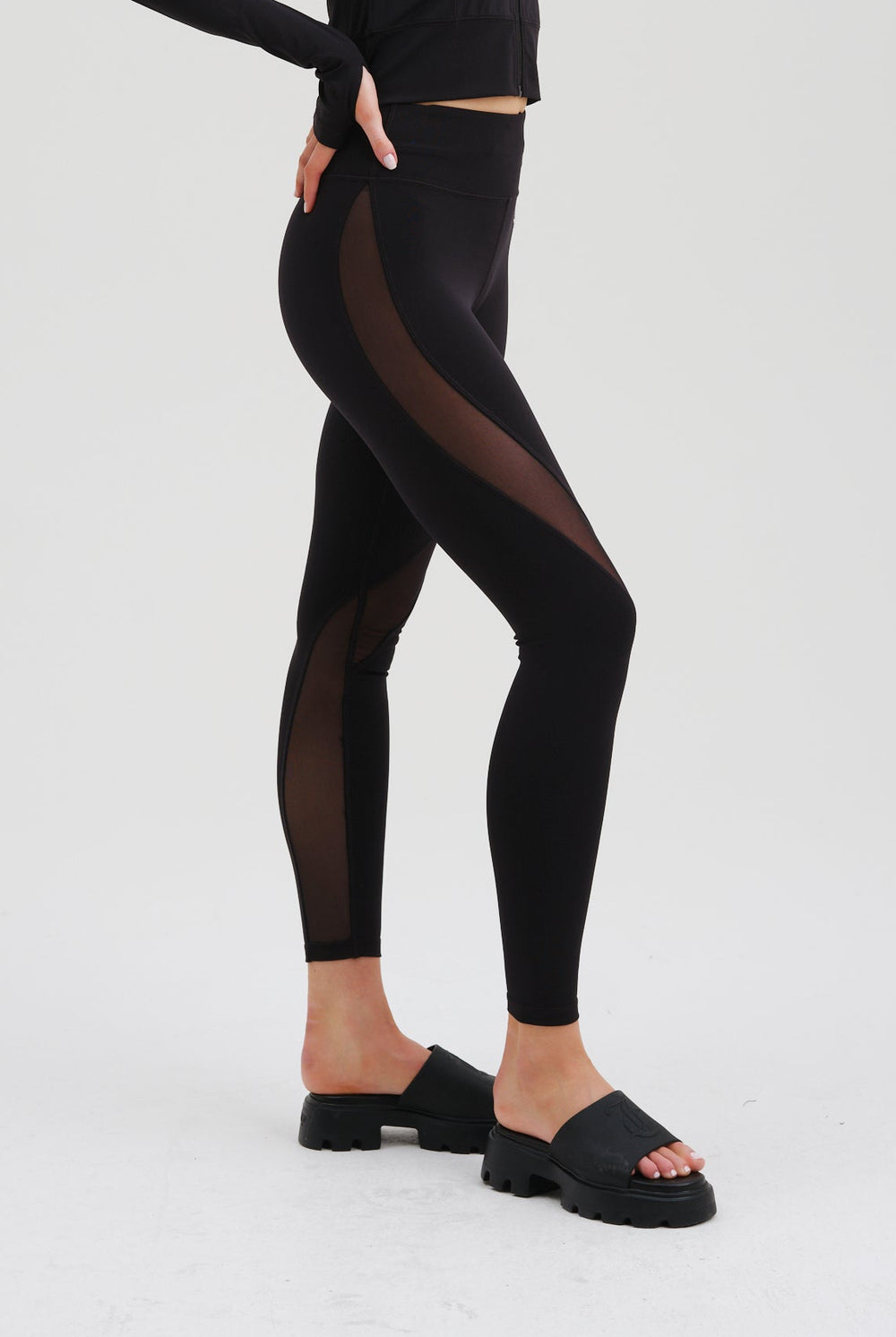 Displays a model wearing the Black 'Juicy' branded black rib peached interlock active legging 