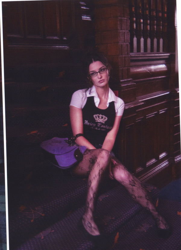 Displays a model wearing the black 'juicy' branded ribbed diamanté crown vest 