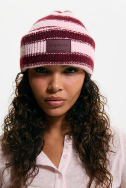 Displays a model wearing the Burgundy Stripe 'Juicy' branded Ribbed Beanie