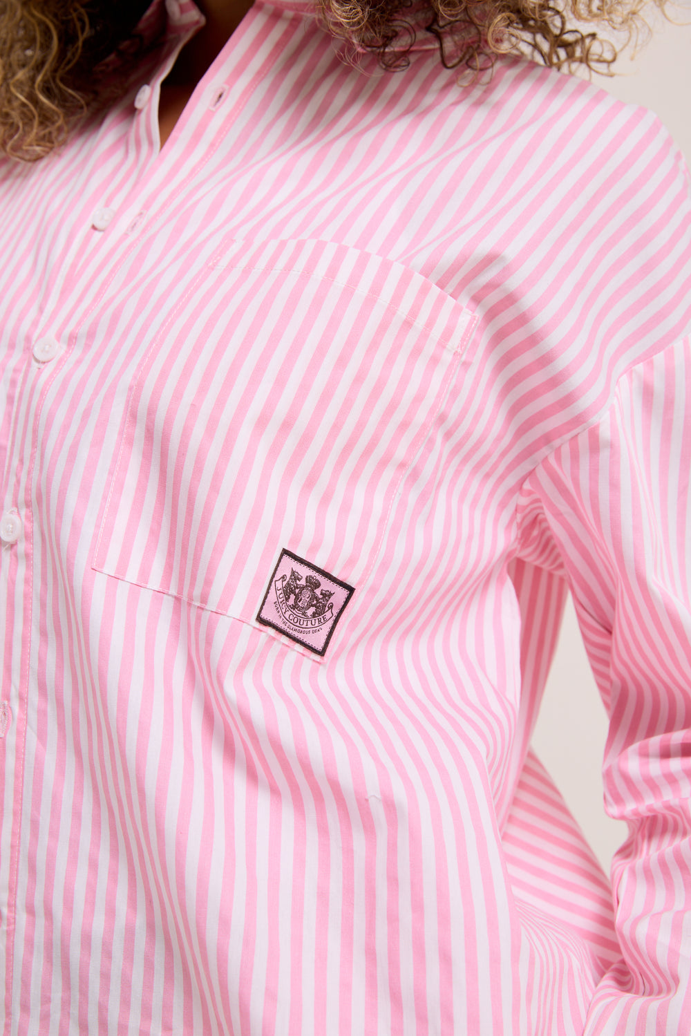 Displays a model wearing the Pink stripe 'Juicy' branded loungewear oversized shirt featuring the Juicy Couture logo