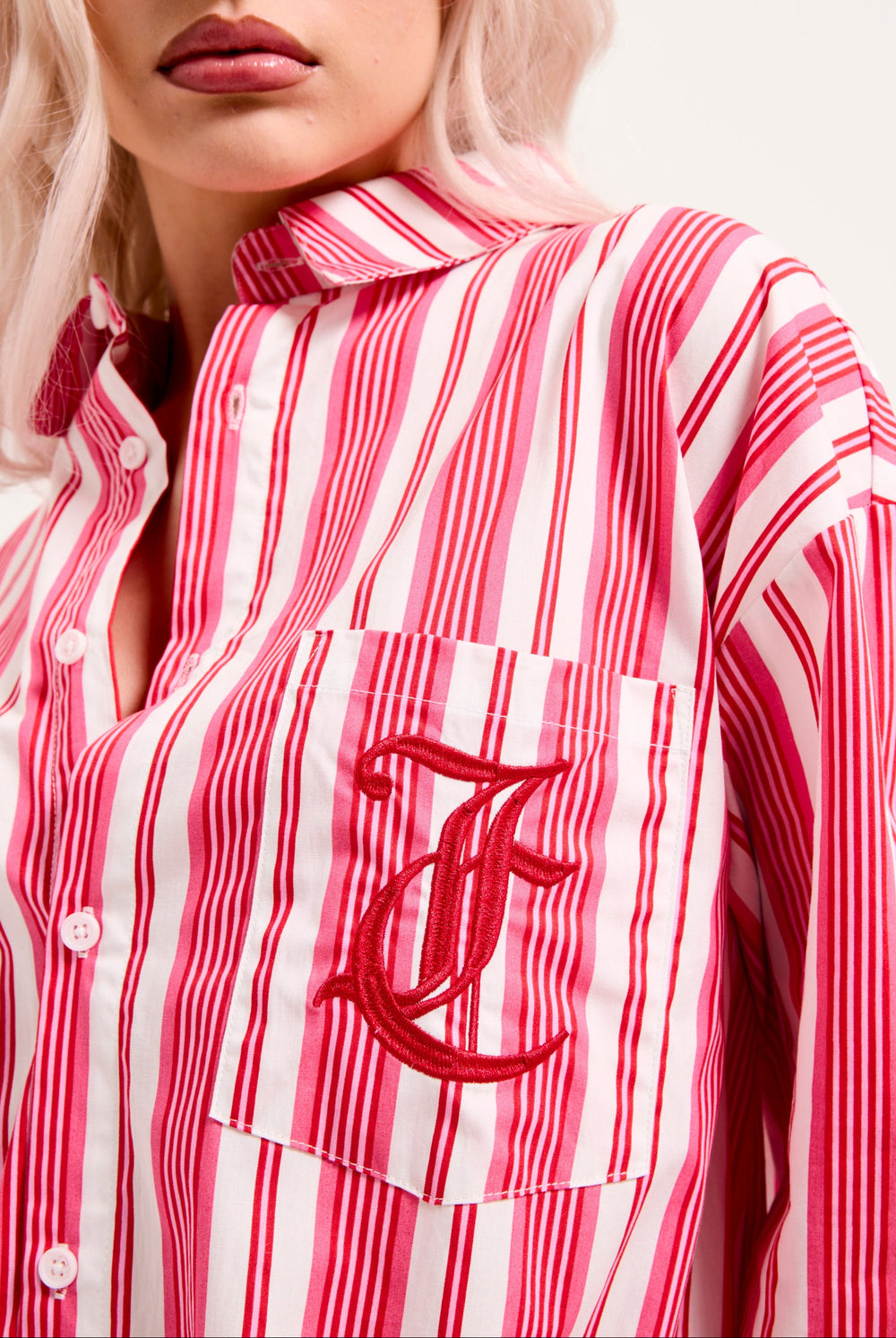 Displays a model wearing the Pink Stripe 'Juicy' branded oversized sleep shirt featuring the juicy couture logo