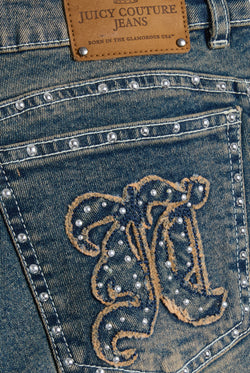 Displays the Mid Wash 'Juicy' branded Sand Stud Moto Bootcut Jeans featuring the details on the juicy Couture logo branding 