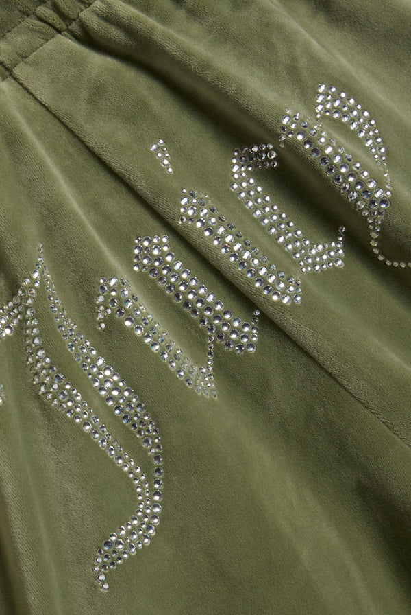 Displays the Oil Green 'Juicy' branded Velour Diamanté Tracksuit Bottom featuring the juicy branding 