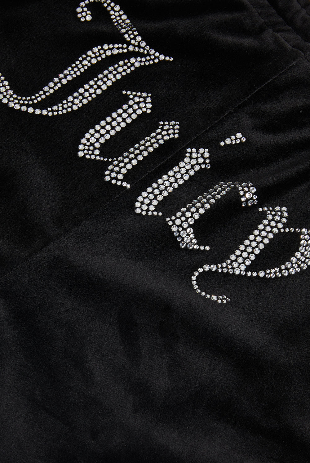 Black velour tracksuit bottoms with diamanté branding on the back