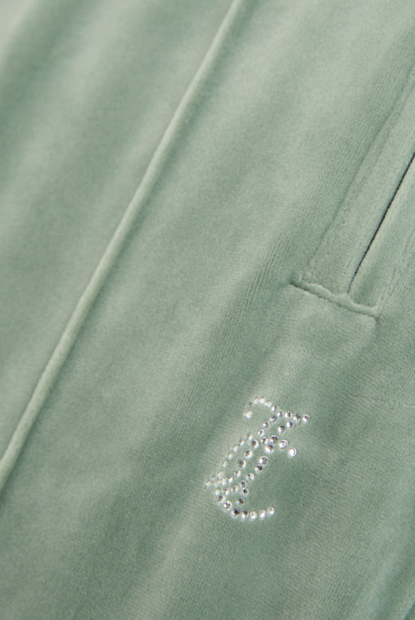 Displays the chinois green 'Juicy' velour diamanté tracksuit bottom featuring the juicy Couture logo