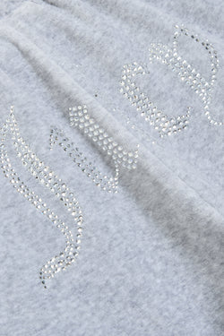 Displays a model wearing the Silver Marl Diamanté 'Juicy' branded cotton velour tracksuit bottoms featuring the Juicy branding 