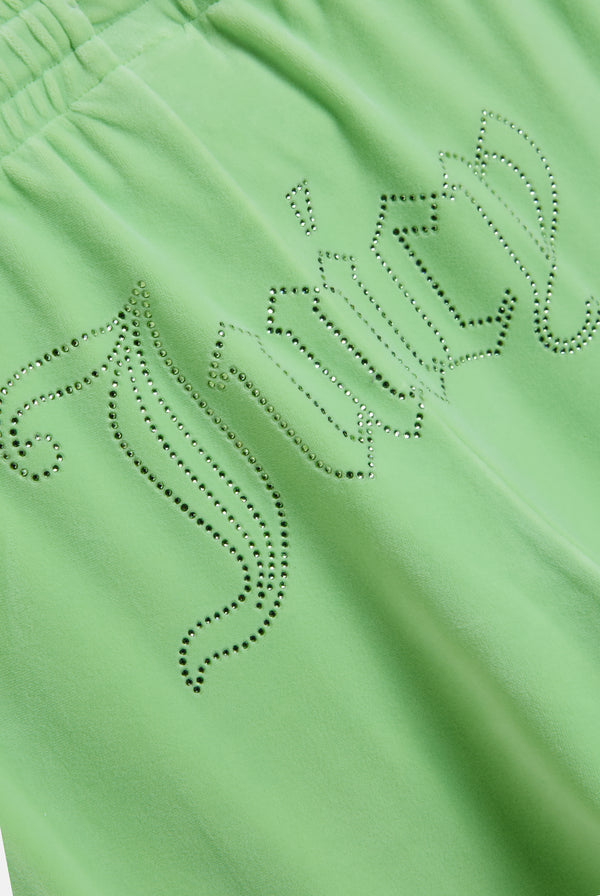 Displays the pistachio green outline 'Juicy' branded velour diamanté tracksuit bottom featuring the juicy branding 