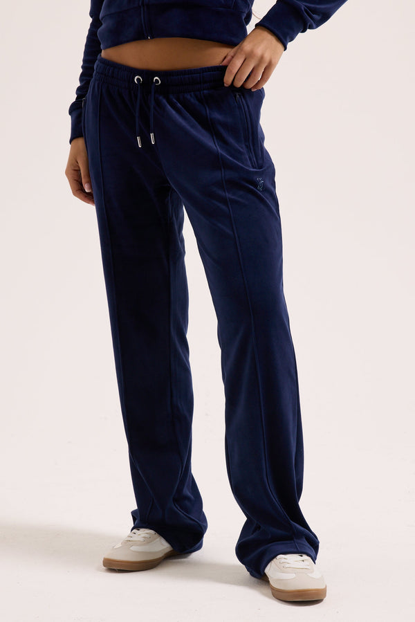Displays a model wearing the Night Sky outline 'Juicy' branded velour diamanté tracksuit bottom 