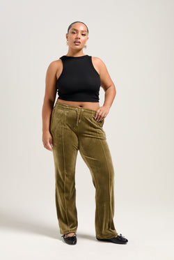 Displays a model wearing the Dark Olive 'Juicy' branded velour diamanté tracksuit bottom