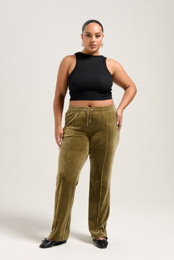 Displays a model wearing the Dark Olive 'Juicy' branded velour diamanté tracksuit bottom