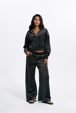 Displays a model wearing the Raven 'Juicy' branded Velour Bonded Tracksuit Bottom