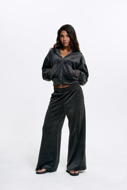 Displays a model wearing the Raven 'Juicy' branded Velour Bonded Tracksuit Bottom
