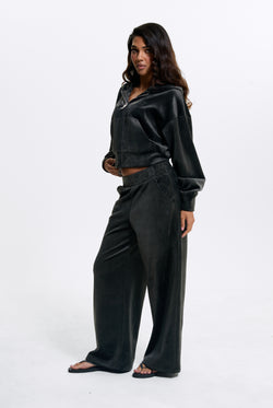 Displays a model wearing the Raven 'Juicy' branded Velour Bonded Tracksuit Bottom