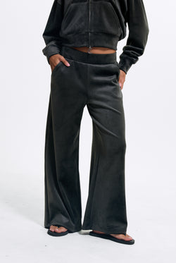 Displays a model wearing the Raven 'Juicy' branded Velour Bonded Tracksuit Bottom