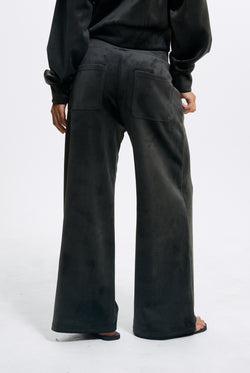 Displays a model wearing the Raven 'Juicy' branded Velour Bonded Tracksuit Bottom