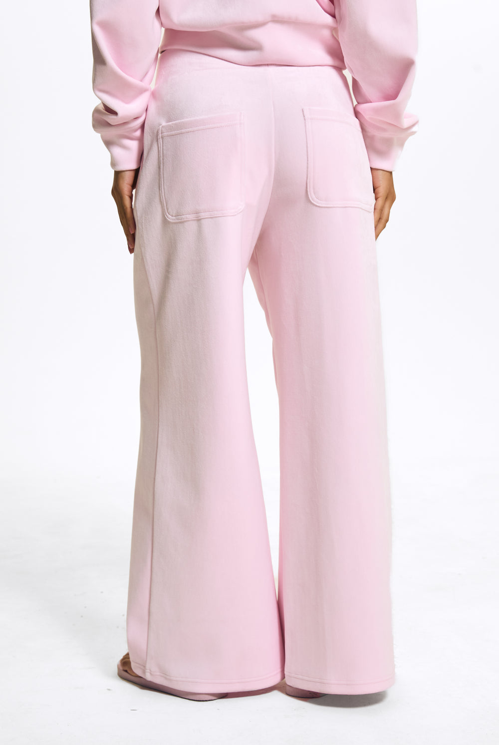 Displays a model wearing the Cherry Blossom 'Juicy' branded Velour Bonded Tracksuit Bottom