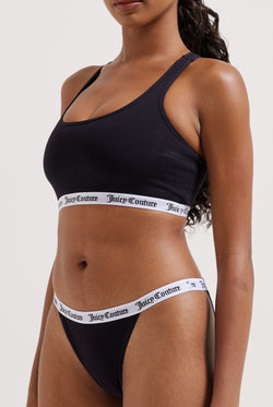 Displays a model wearing the Black 'juicy' branded cotton bralette