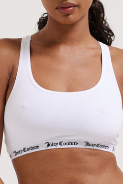 Displays a model wearing the White 'juicy' branded cotton bralette 