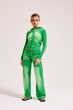 Displays a model wearing the Jolly Green washed 'juicy' branded cotton velour fitted hoodie 