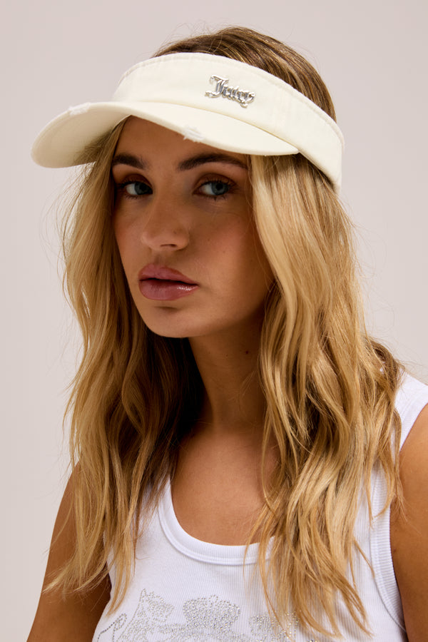 Displays a model wearing the ecru distressed 'Juicy' branded cotton denim visor 