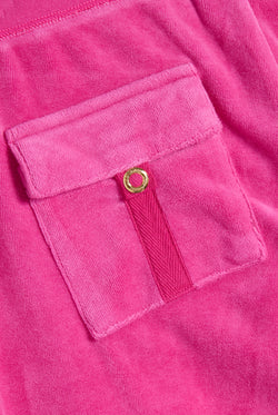 Displays the Nostalgia Pink 'Juicy' branded Washed Caisa Ultra Low Rise Pant featuring the details on the pockets 