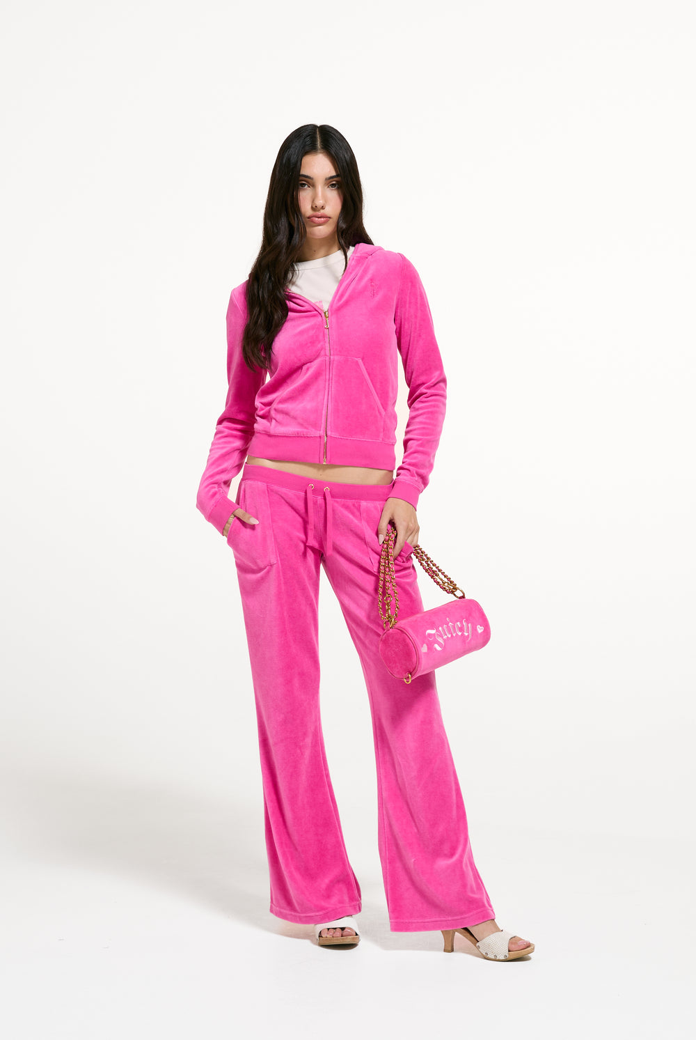 Displays a model wearing the Nostalgia Pink 'Juicy' branded Washed Caisa Ultra Low Rise Pant