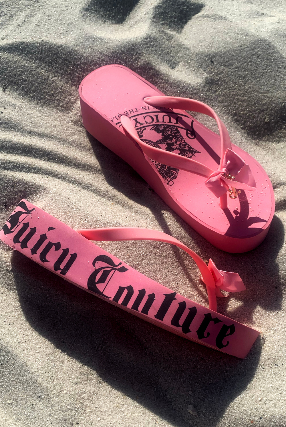 Displays a pair of the Pink 'Juicy' branded heritage wedge sliders 