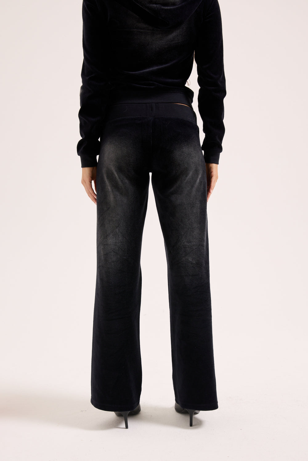 Displays the washed black cotton 'Juicy' branded velour og straight low rise pants 