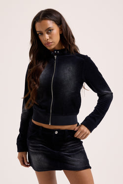 Displays a model wearing the washed black 'juicy' branded cotton velour moto jacket