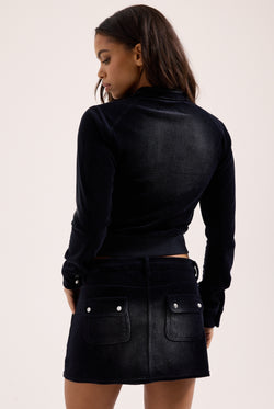 Displays a model wearing the washed black 'juicy' branded cotton velour moto jacket