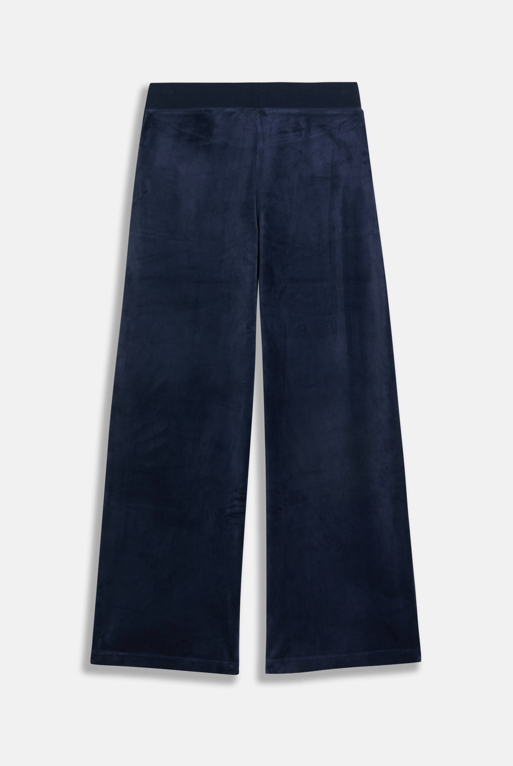 Displays a model wearing the night sky 'juicy' branded Sky Wide leg classic velour track pant 