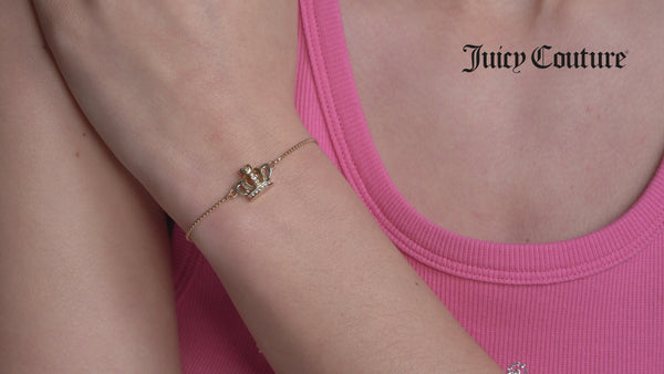 Displays a model wearing the 'Juicy' Gold Tone Crystal Icon Crown Adjustable Bracelet