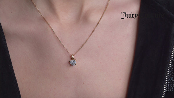 Displays a model wearing the 'Juicy' Gold Tone Solitaire Crystal Heart Pendant